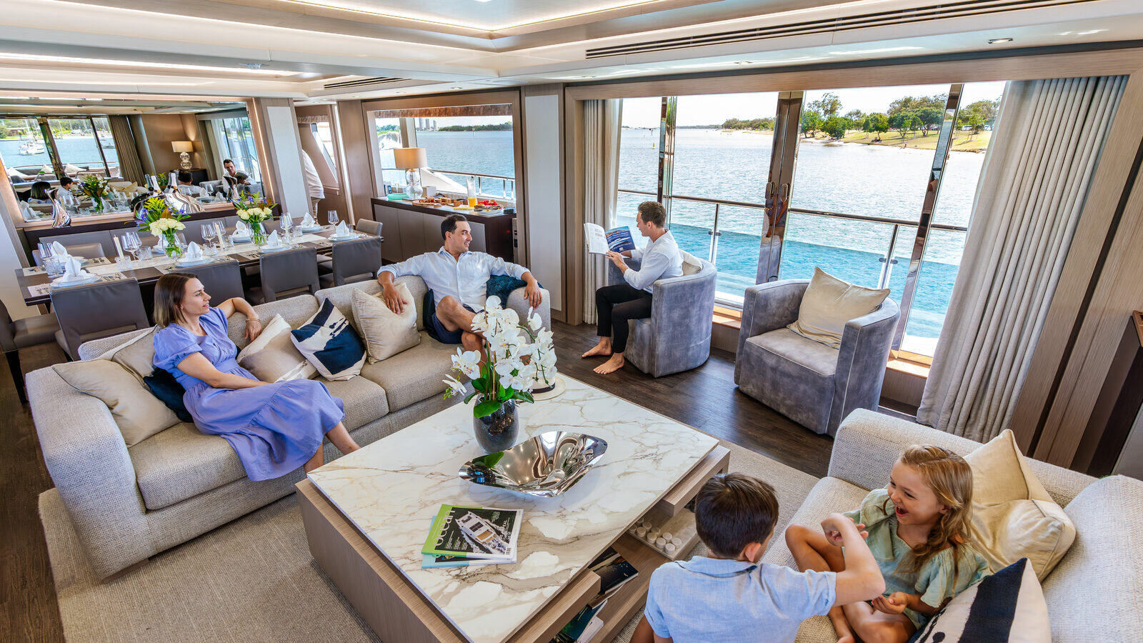 Guests relaxing in the saloon of a luxury charter yacht on the Gold Coast Broadwater