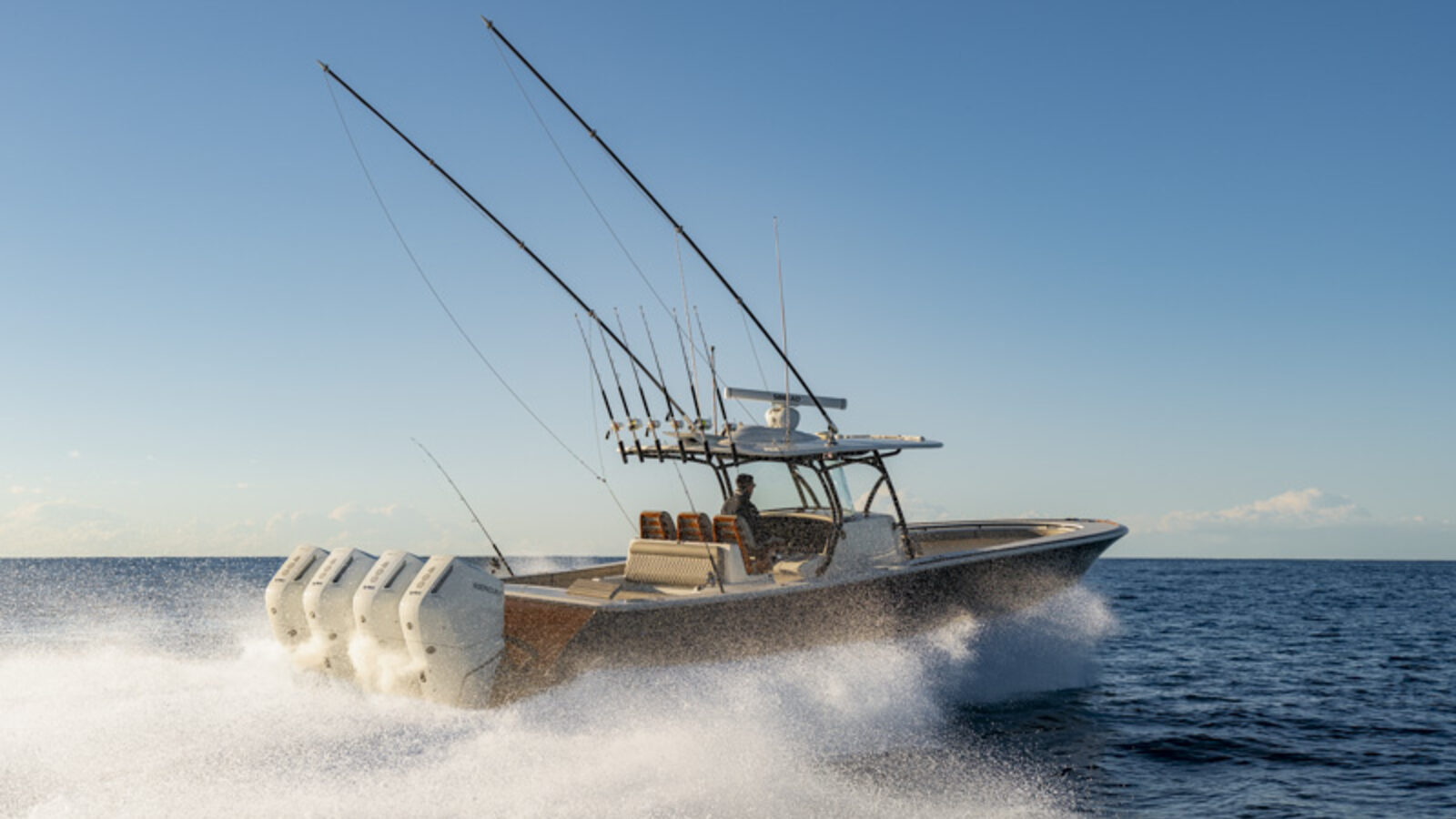 A Valhalla V41 centre console underway offshore, quad outboards throwing spray